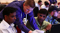 Speaker assisting attendees during a Hands-On Workshop