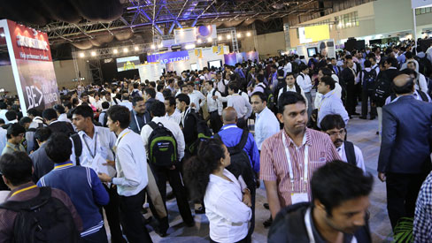 Attendees visit exhibitors at SAP TechEd 2012 Bangalore